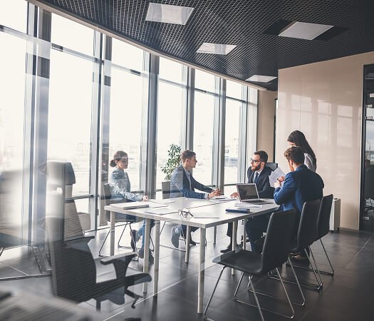 Business team meeting around a table in a modern conference room